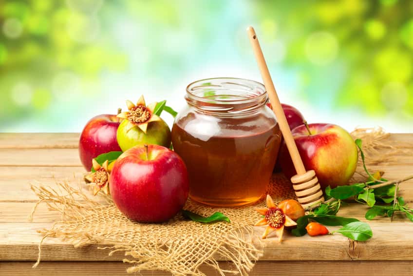 Honey, Apple And Pomegranate On Wooden Table